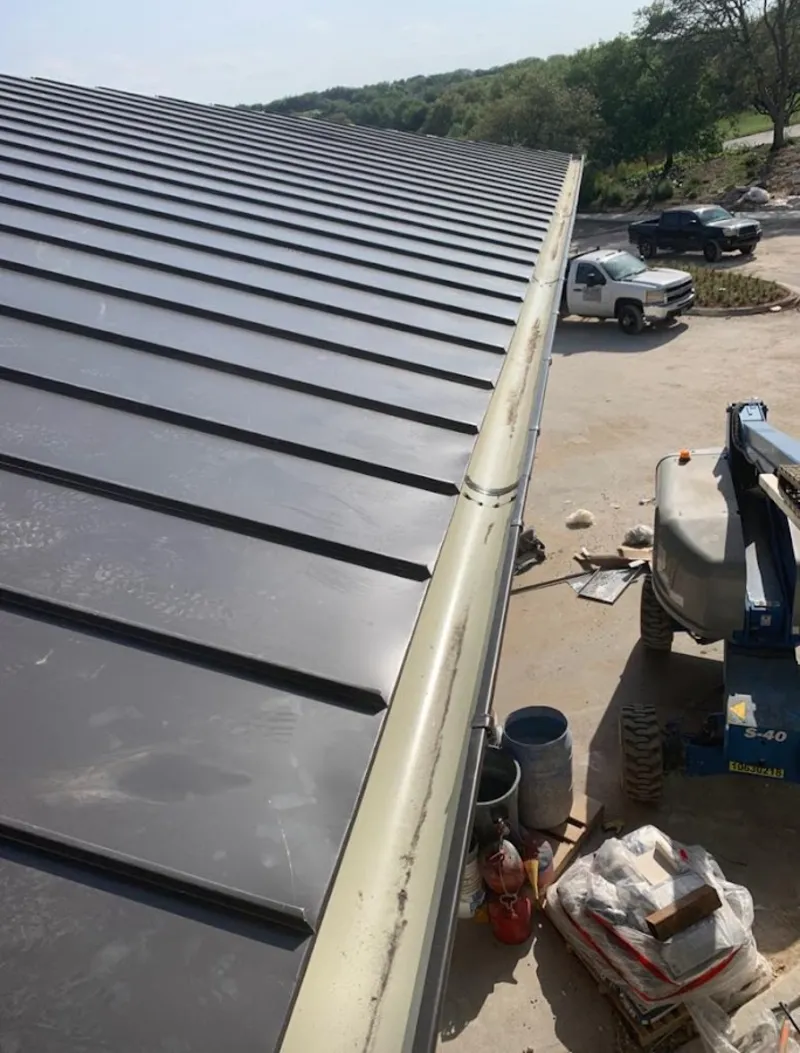 Standing seam panel and gutter detail on a metal roofing jobsite in McGregor
